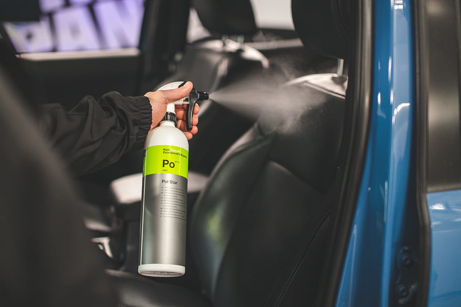 KOCHCHEMIE bottle with microfiber mitt in a workshop showing ready-to-use detailing kit