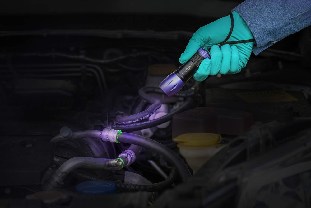LEAKFINDER dye glowing under UV light revealing a refrigerant leak
