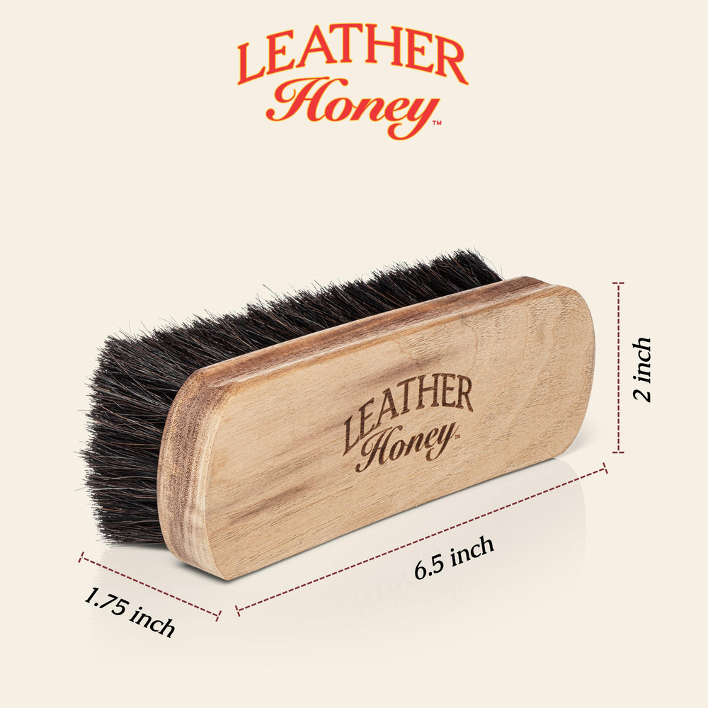 Leather Honey brush on sofa surface lifting dust for cleaner furniture maintenance