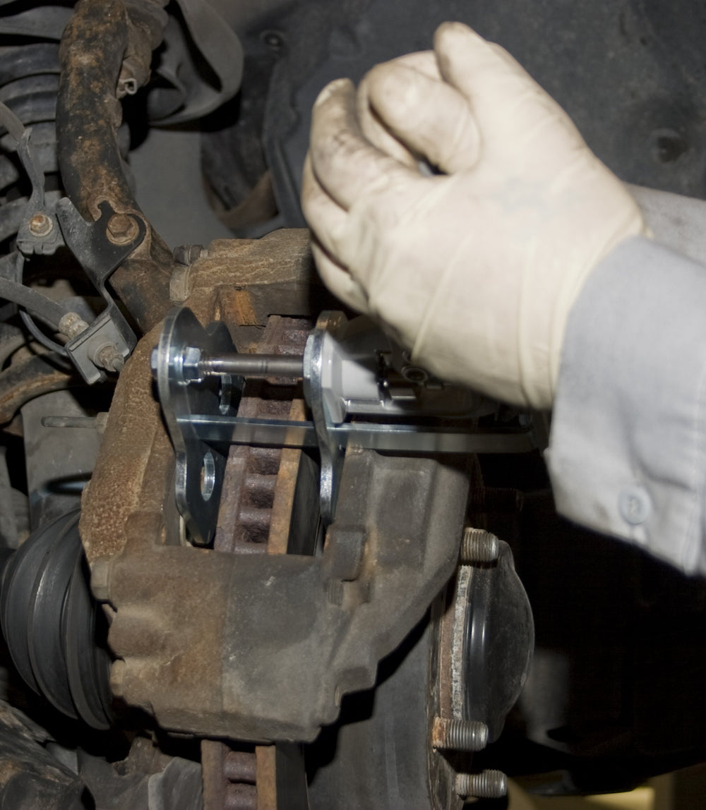 Lisle 29100 in use on caliper compressing pistons safely for faster pad replacement