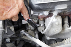 Lisle 51420 in use gripping a spark plug boot for damage-free removal