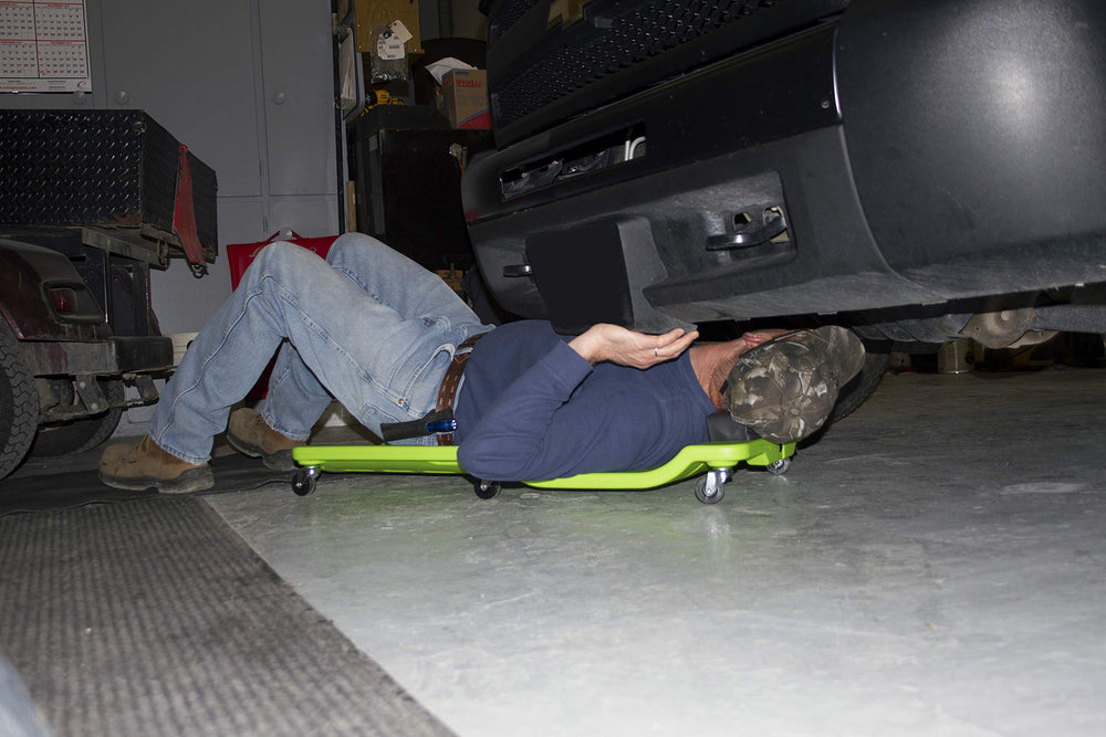 Lisle creeper under car in garage showing comfortable access during repairs