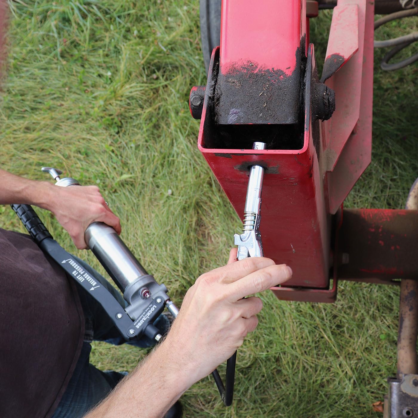 LockNLube coupler attached to a Zerk fitting delivering clean grease flow