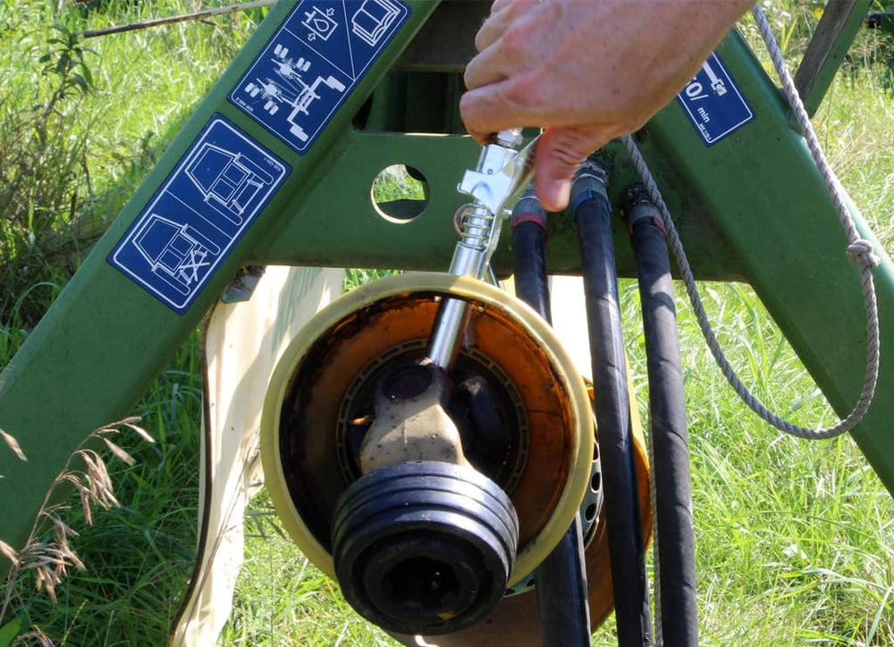 LockNLube thumb release being pressed for quick one-hand disconnect