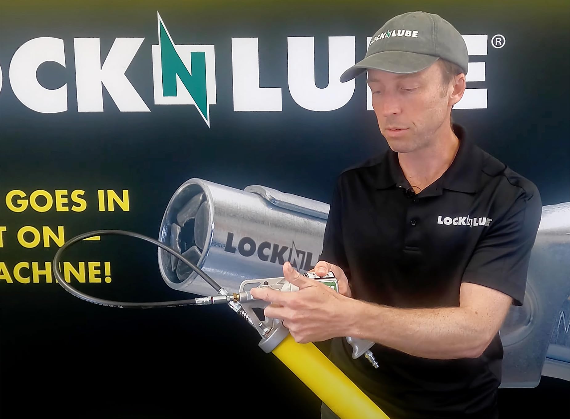LockNLube grease gun held by hand for size comparison showing comfortable handling and portability