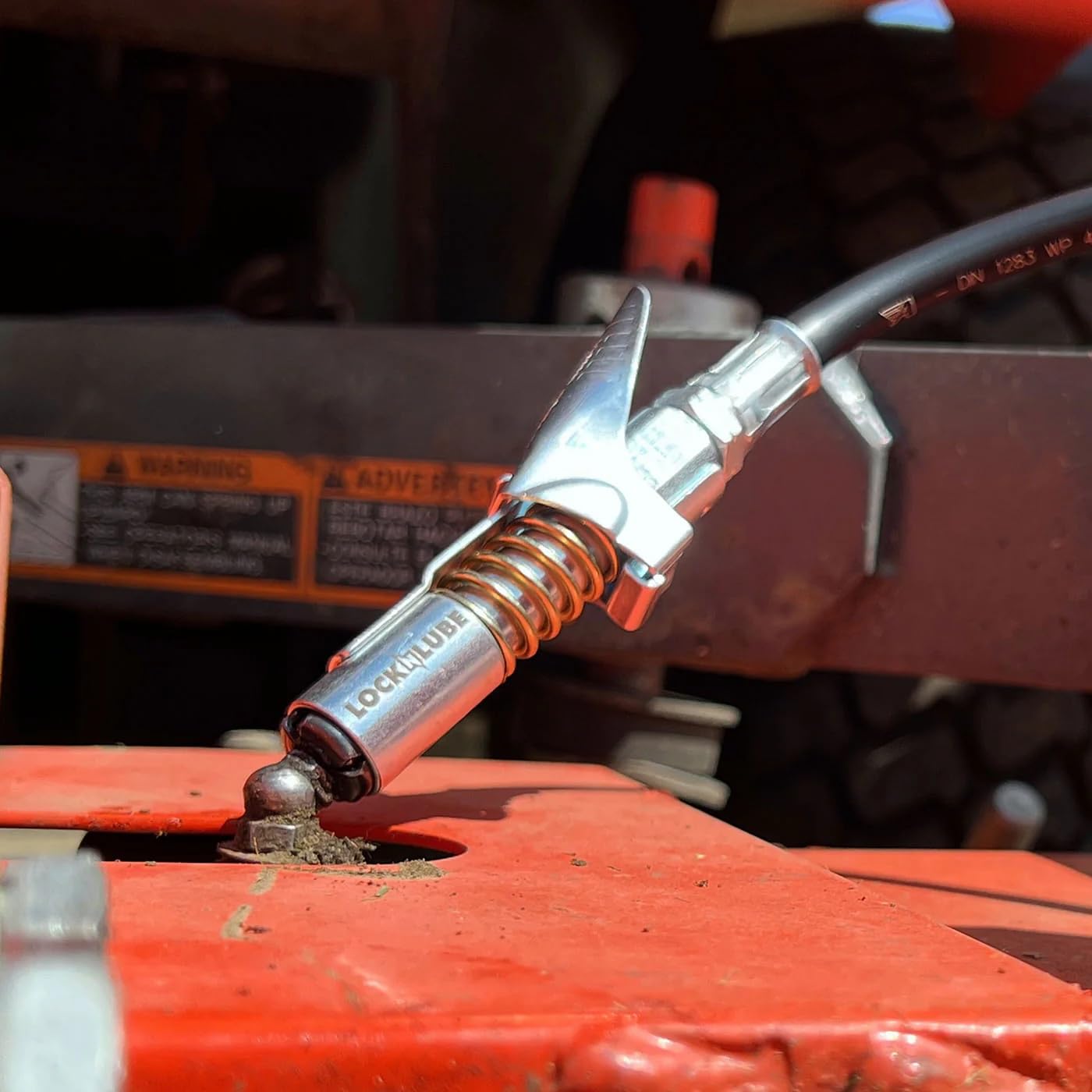 LockNLube in a workshop setting conveying professional, mess-free greasing