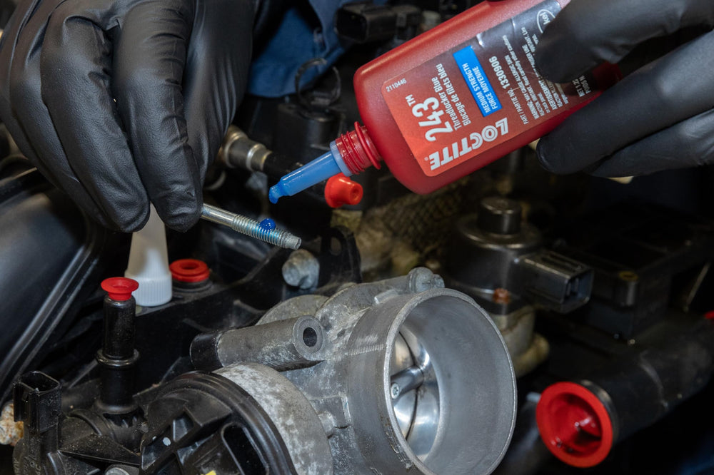 Loctite 243 bottle with hand tools staged for repair work