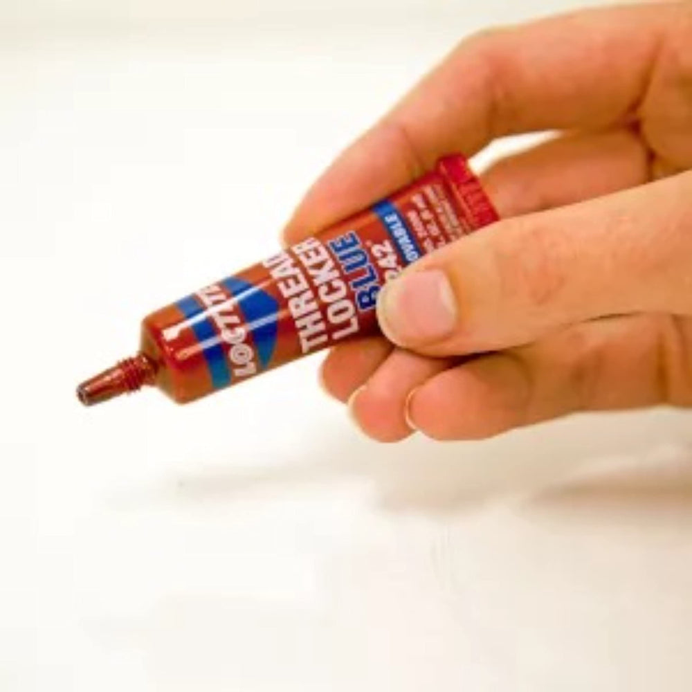 Loctite applied to a mower bolt protecting equipment from vibration
