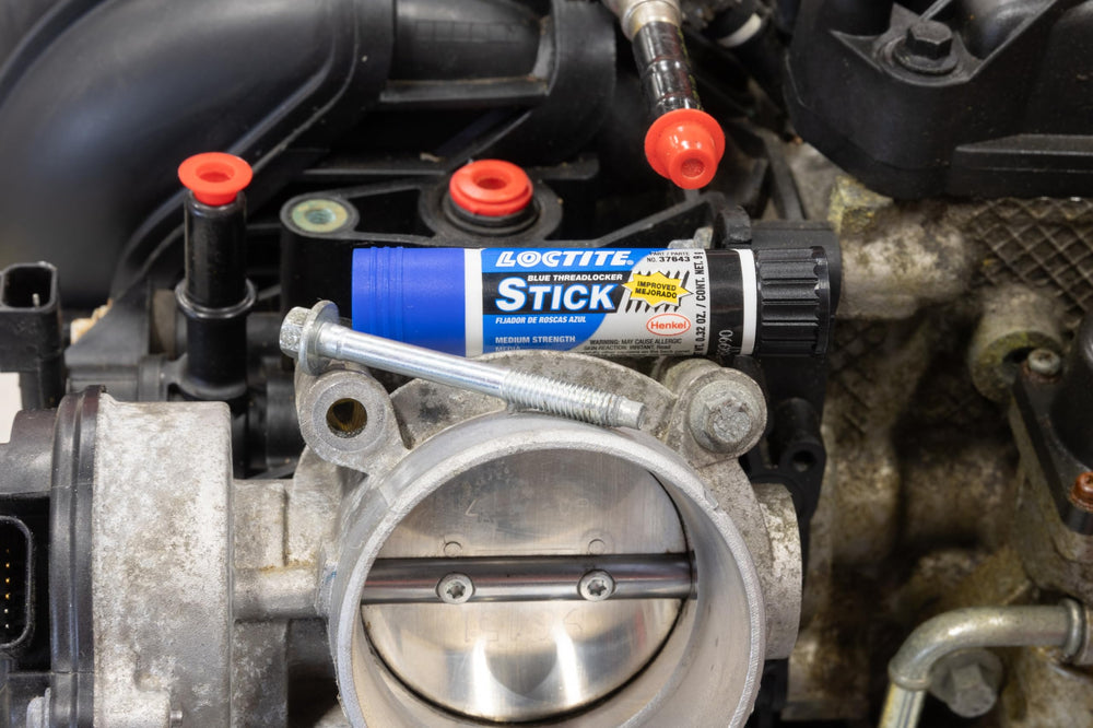 Loctite in garage setting showing reliable automotive maintenance benefit