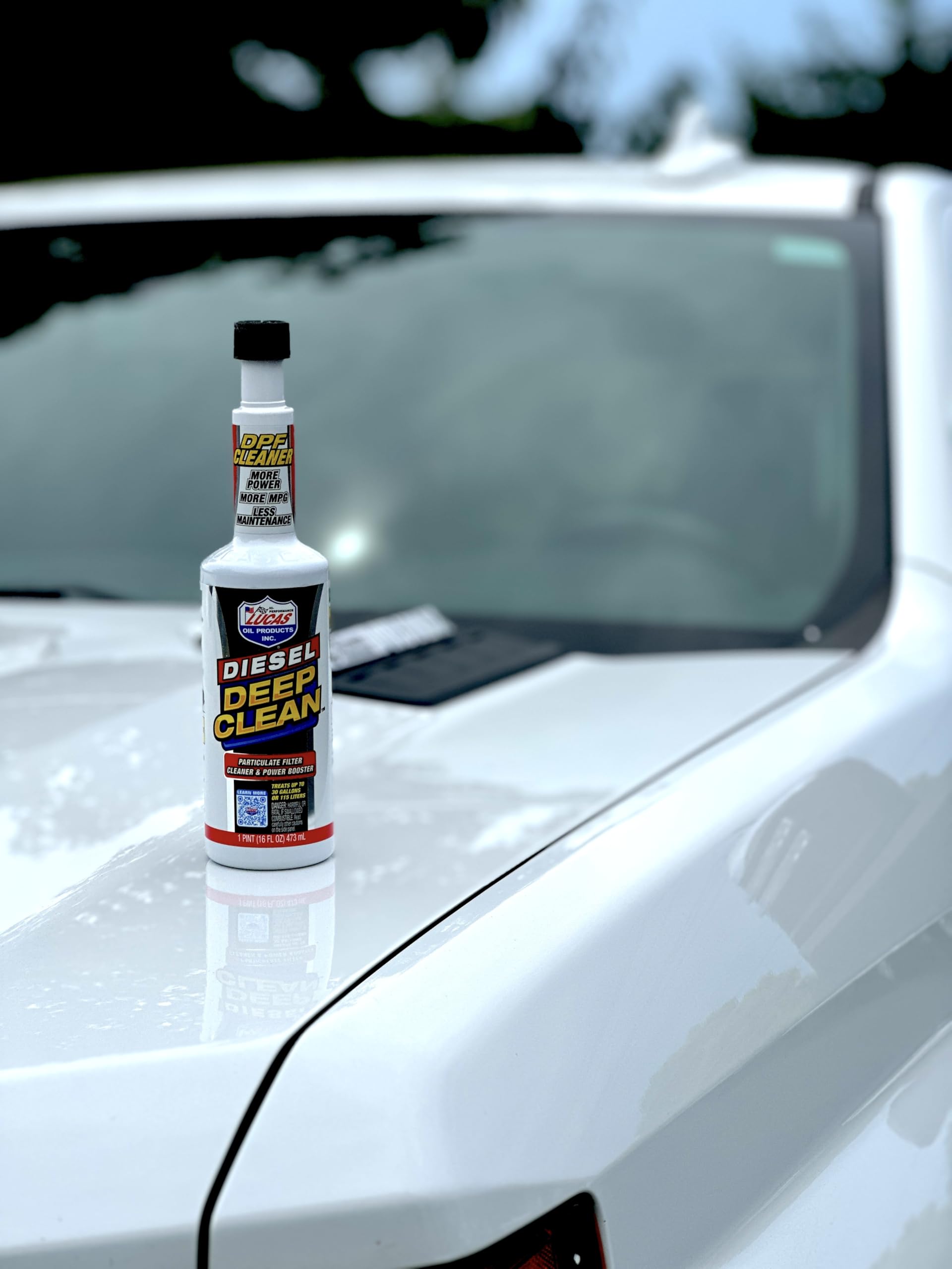 Lucas Oil being poured into a fuel tank to reduce DPF regens while refueling