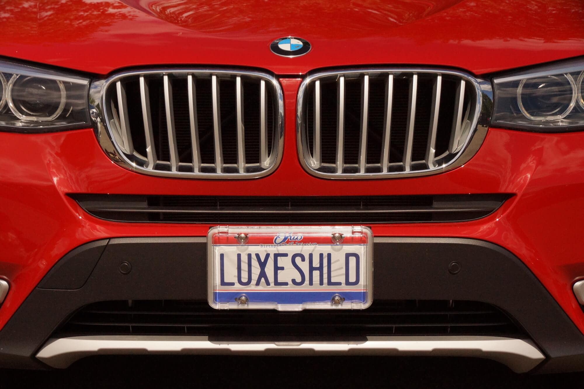 Luxe Shield in hand showing scale and easy-install benefit
