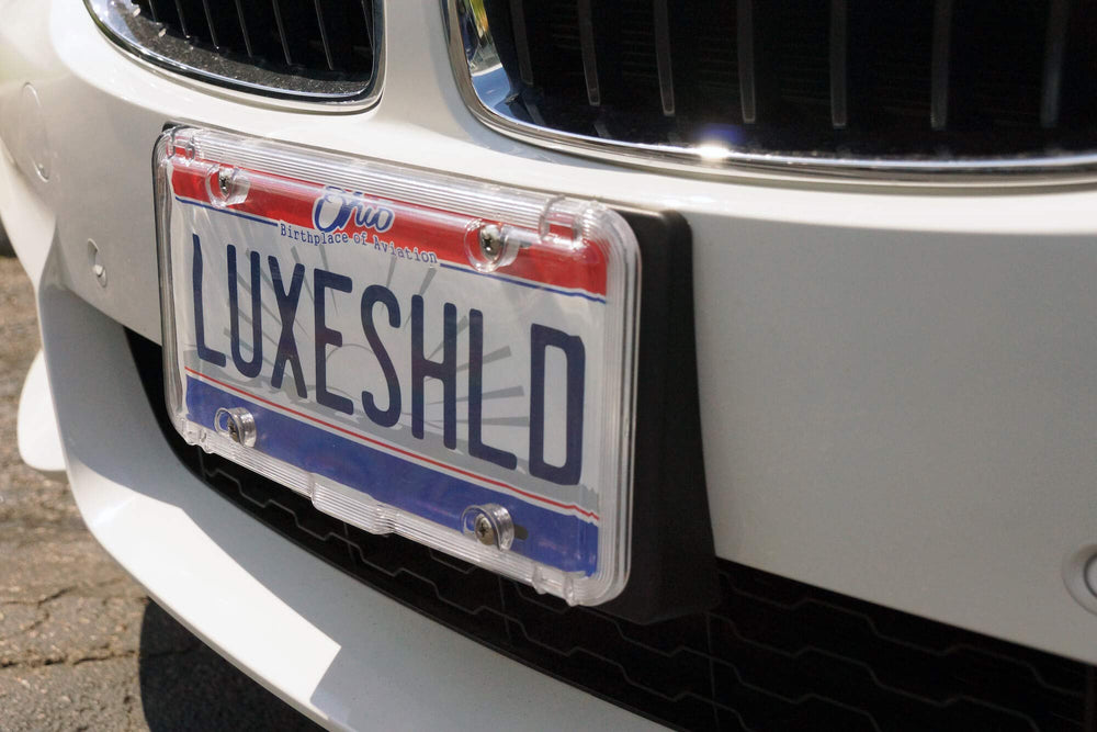 Luxe Shield installed on a sedan rear showing secure weatherproof protection benefit