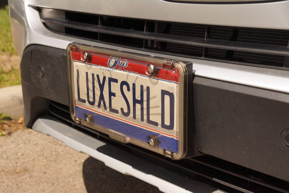 Luxe Shield installed on vehicle front preserving plate clarity and legal visibility benefit