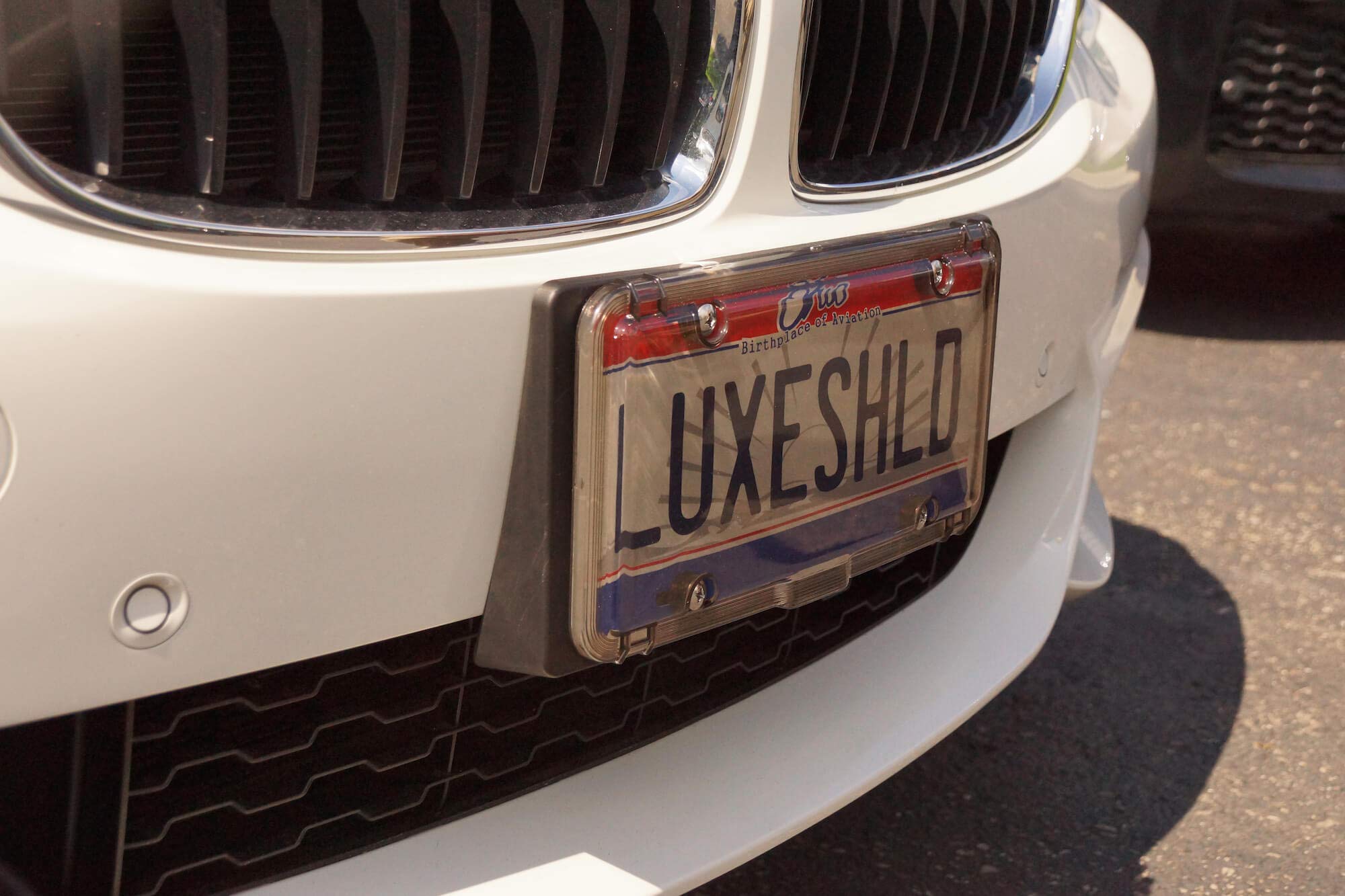 Luxe Shield lifestyle driveway shot conveying polished look and vehicle enhancement benefit