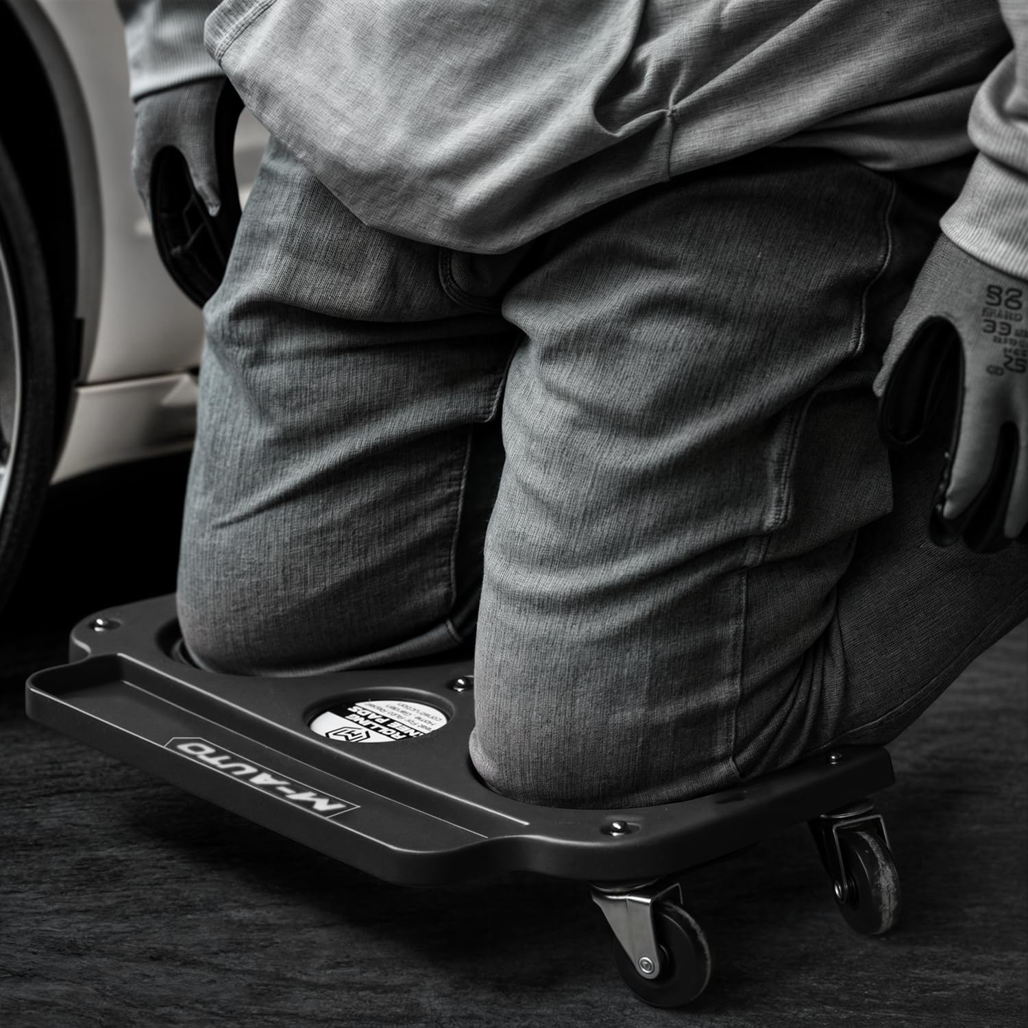 M-AUTO user kneeling and moving showing ergonomic mobility during repair