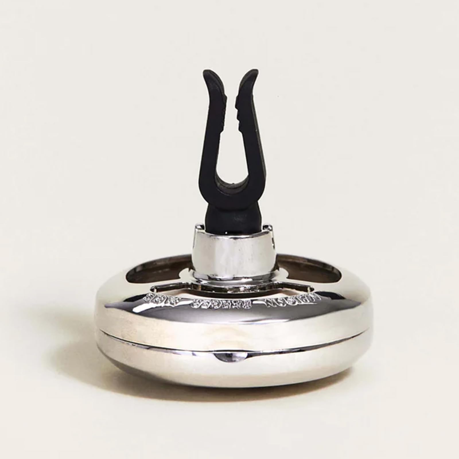 MAISON BERGER diffuser beside coin to show compact size and easy portability