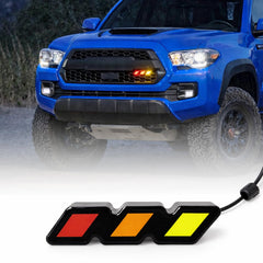 Medwoka front view installed on grille showing bold tri-color pop