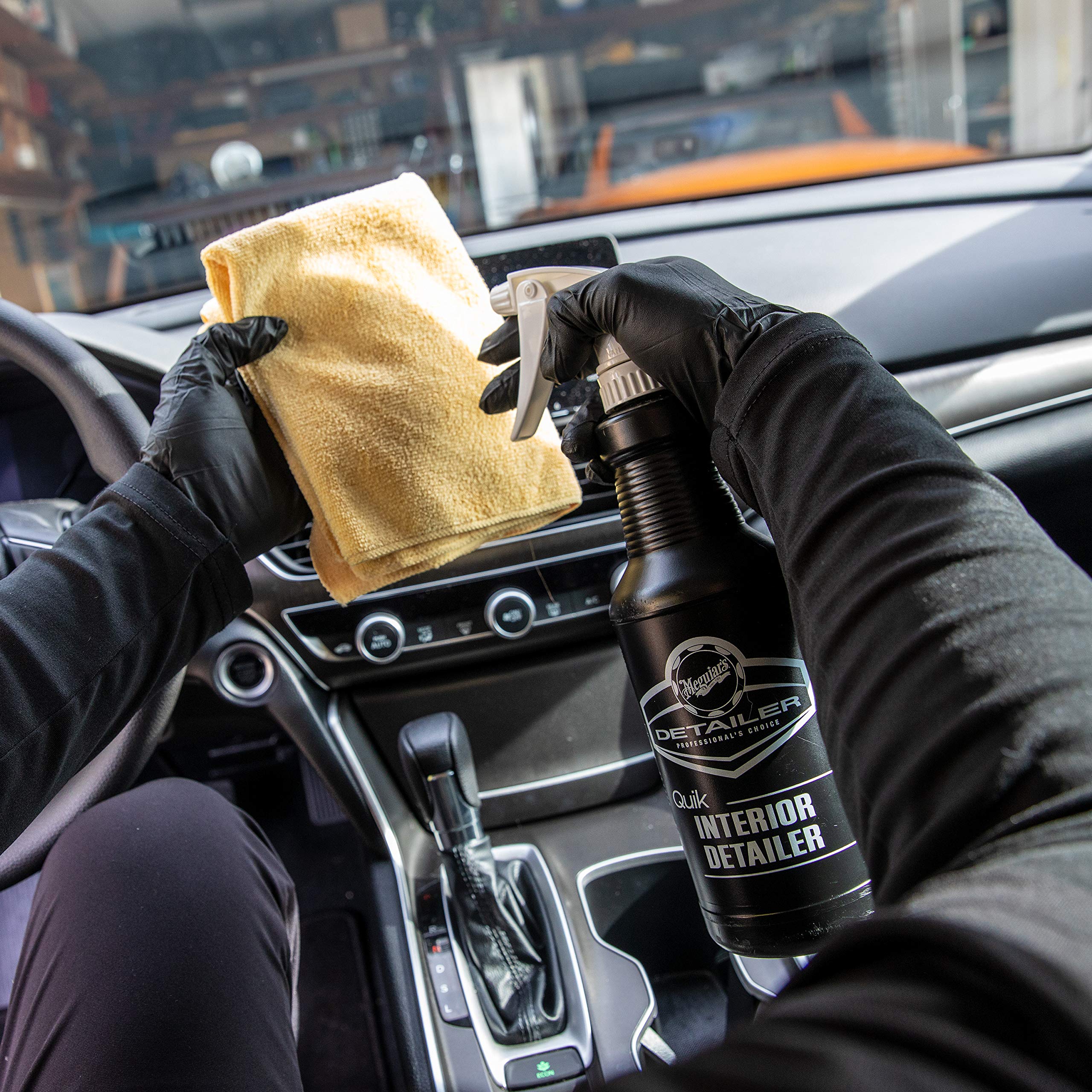 Meguiar's bottle beside a hand for scale showing refill convenience benefit