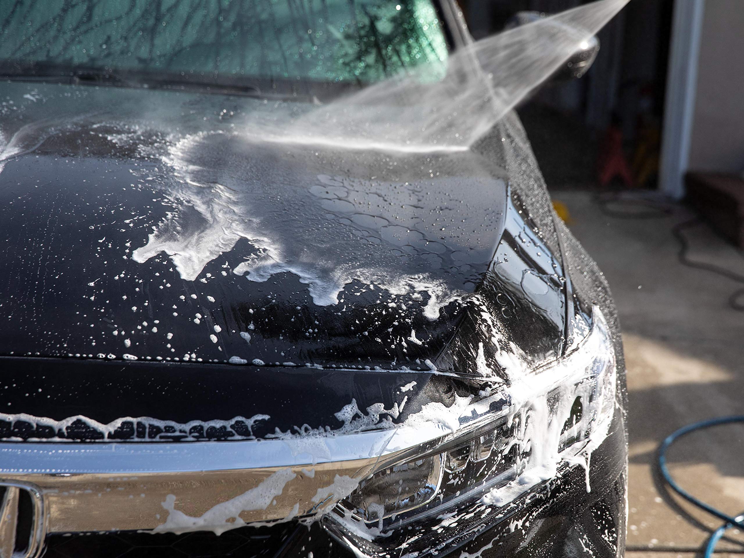 Meguiar's D111 on driveway during detailing, delivering glossy finish