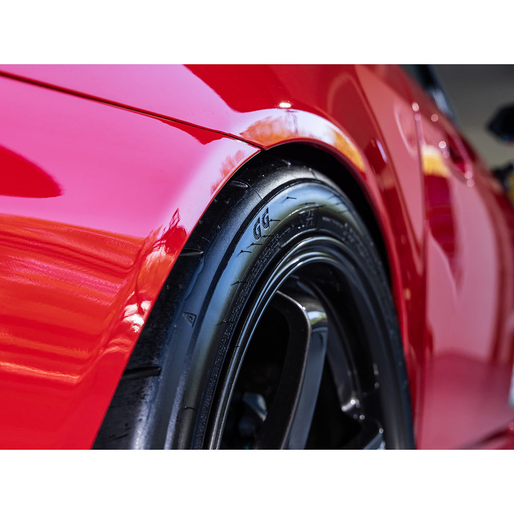 Meguiar's car side view with treated tires illustrating on‑vehicle finish