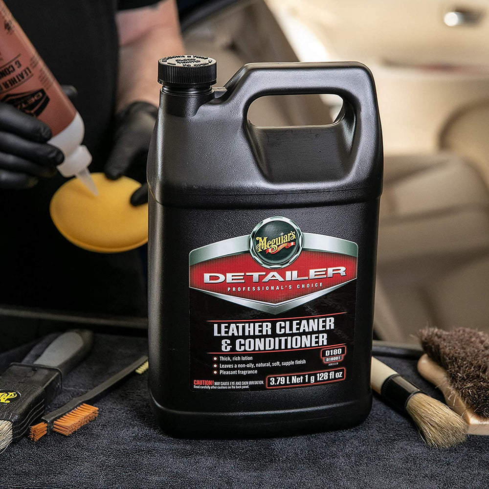 Meguiar's being sprayed by a detailer on a car seat demonstrating fast, even cleaning benefit