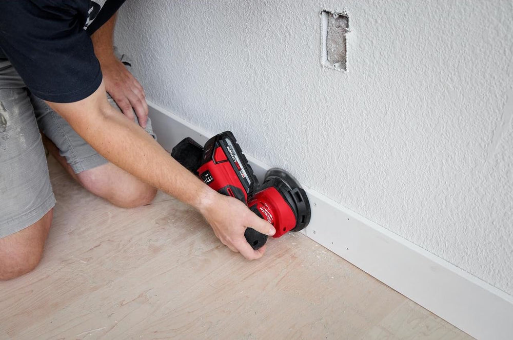 Milwaukee M18 FUEL sander attached to dust bag for cleaner work areas
