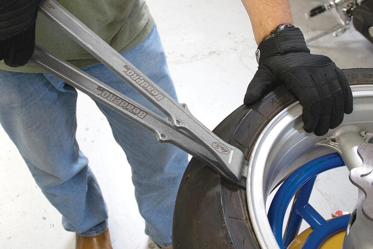 Motion Pro tool in use on motorcycle wheel demonstrating safe bead separation