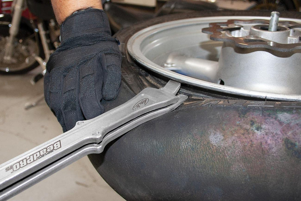 Motion Pro tool next to tape measure illustrating 16-inch handle for increased leverage