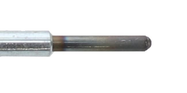 Motorcraft glow plug next to wrench for scale showing compact OEM dimensions benefit