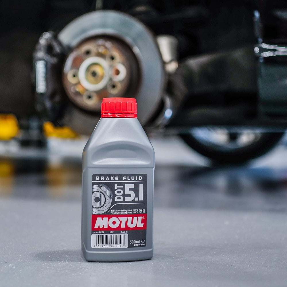 Motul DOT 5.1 being poured into brake reservoir, demonstrating fast fluid flow and system readiness