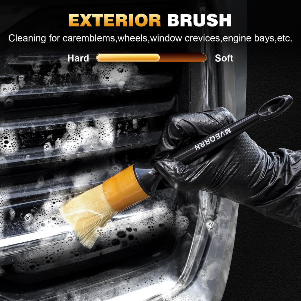 MVEQRRN two deep-clean brushes reaching a dashboard seam to remove trapped dirt