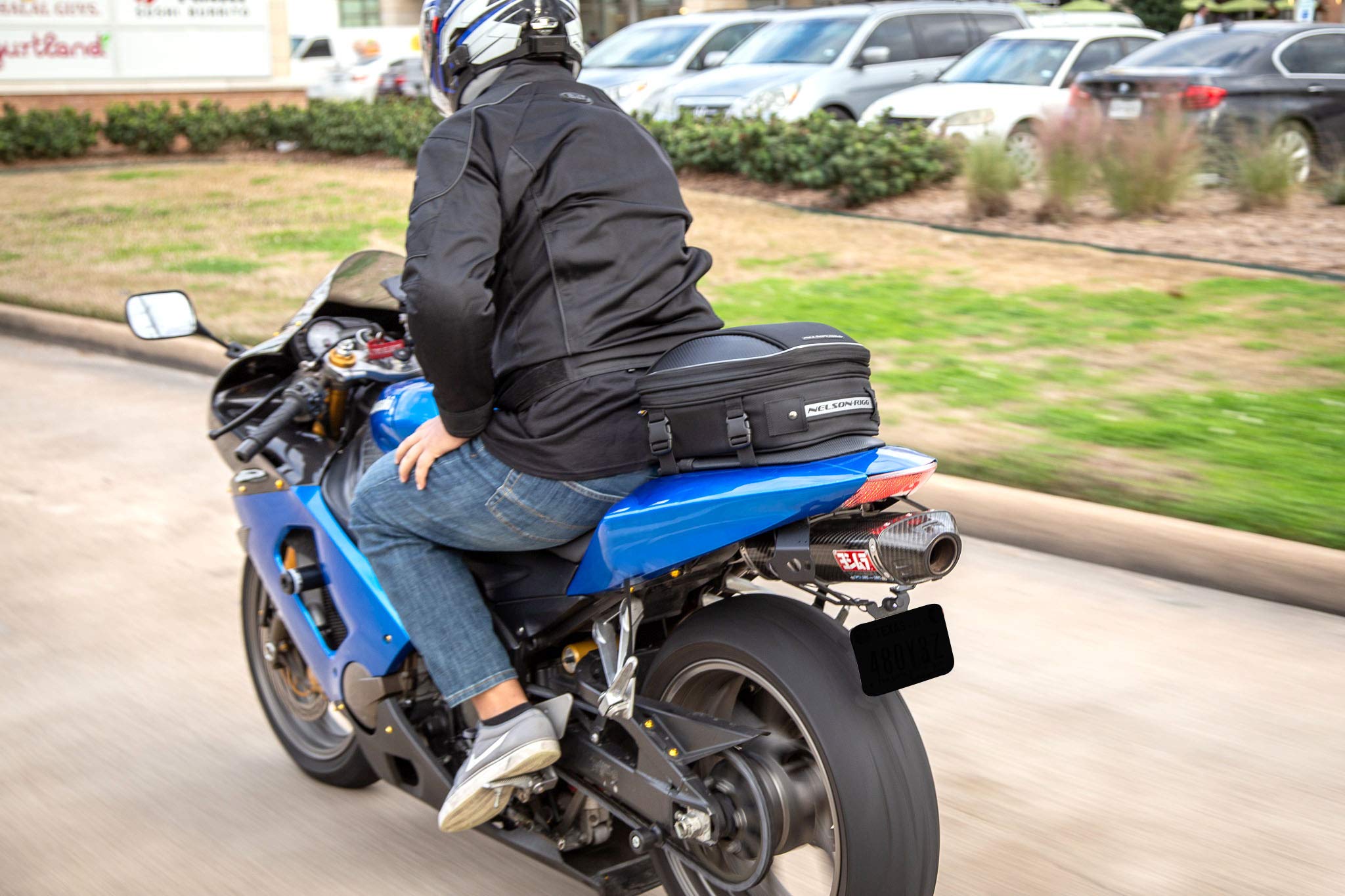 Nelson-Rigg mounted on motorcycle tail demonstrating real-world fit