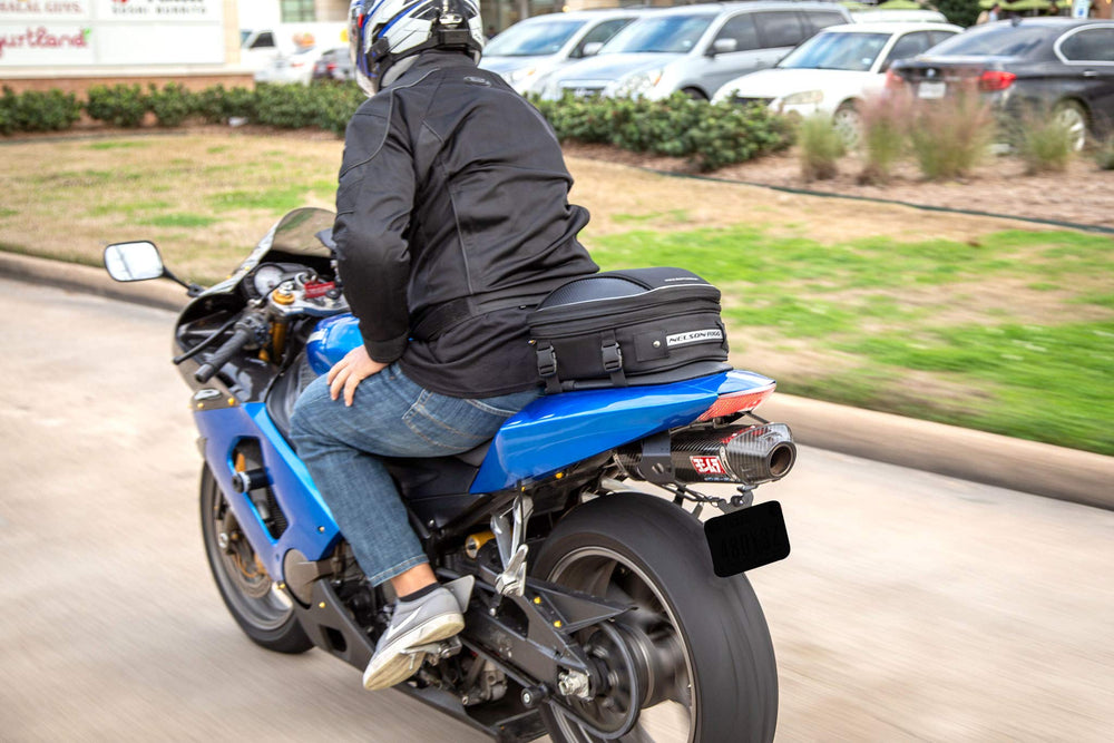 Nelson-Rigg mounted on motorcycle tail demonstrating real-world fit