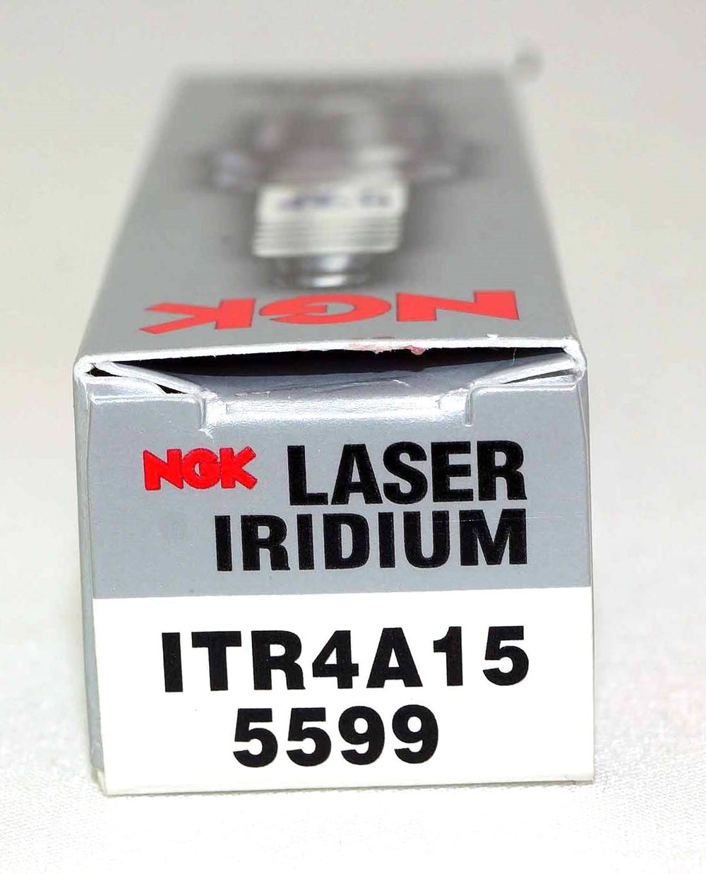 NGK plugs on workbench in garage illustrating professional installation readiness