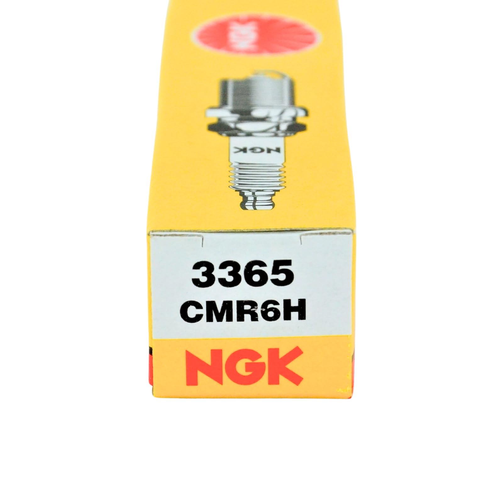 NGK CMR6H on a workbench with tools portraying ready-to-install plugs for professional maintenance