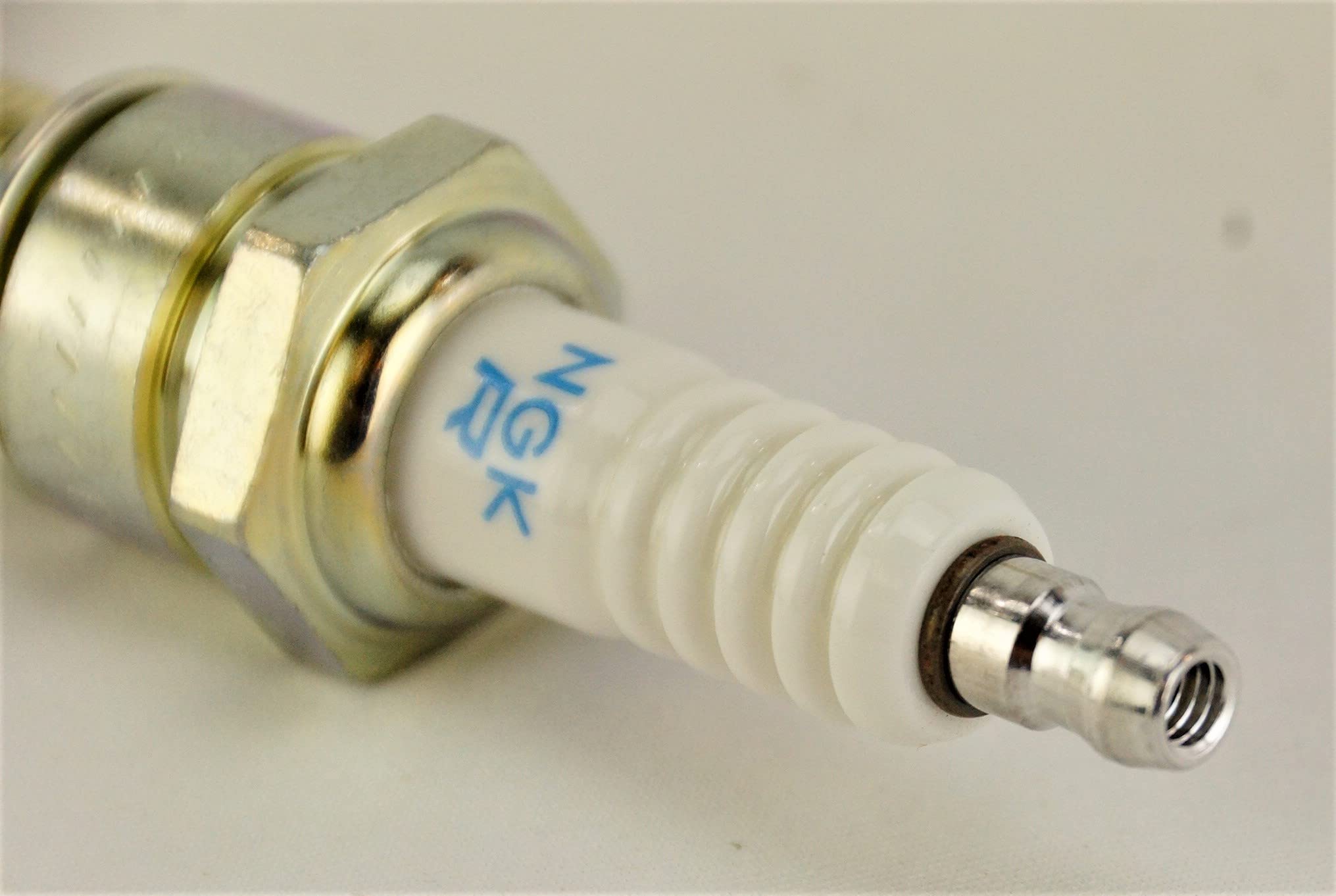 NGK spark plug installed in engine block showing proper placement and fitment
