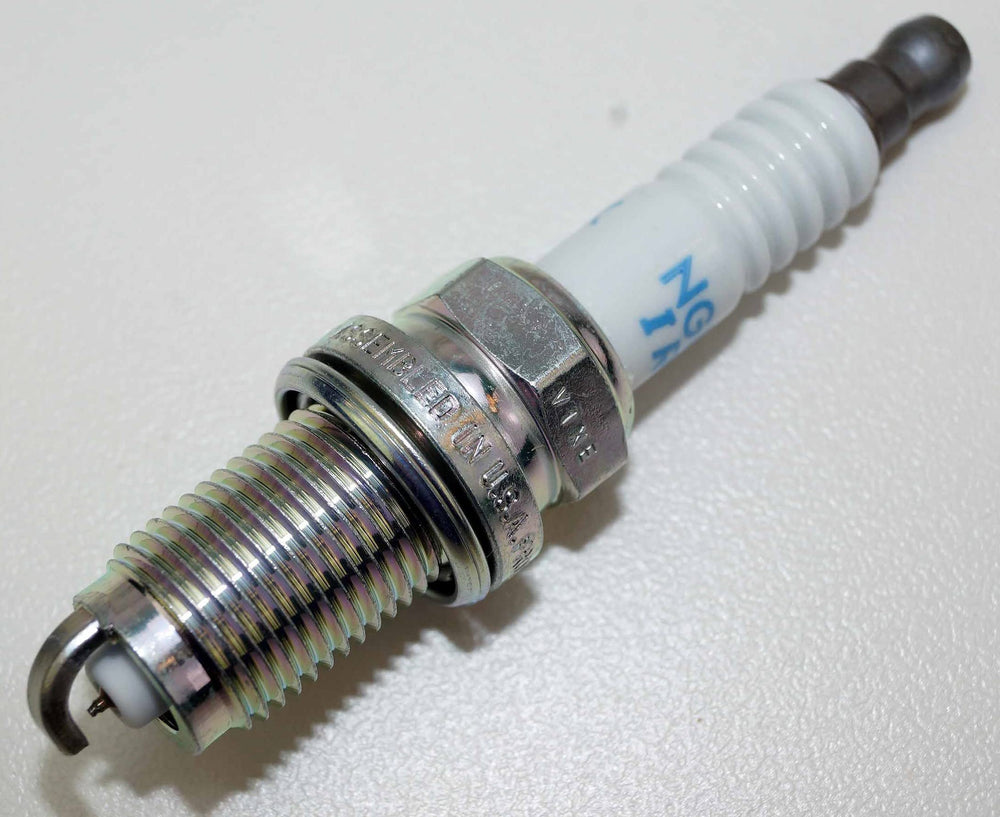 NGK spark plug installed in engine illustrating reliable ignition fit