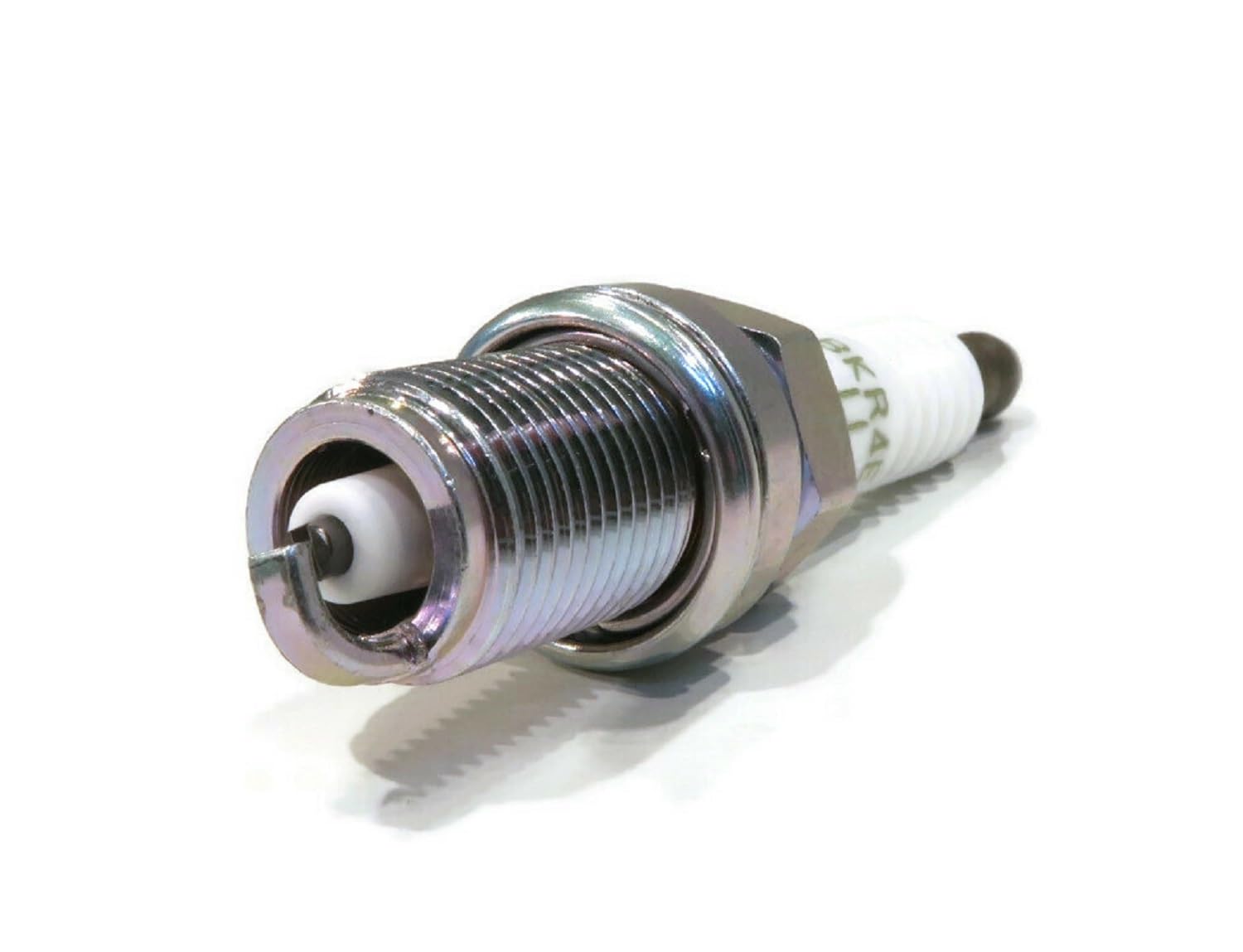 NGK spark plug installed in engine well demonstrating correct fit and accessibility