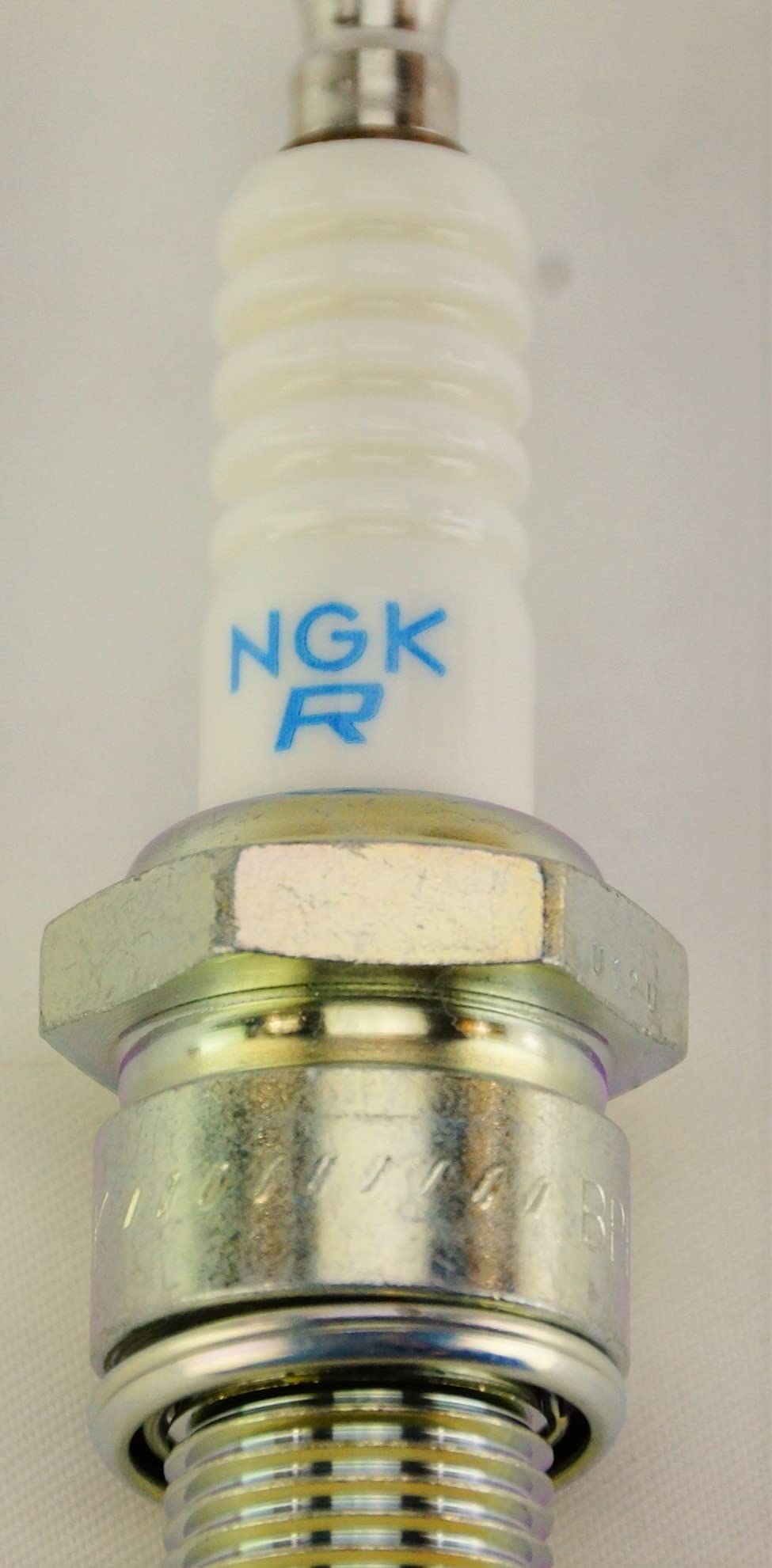 NGK plug next to ruler for scale to confirm size and reach before purchase