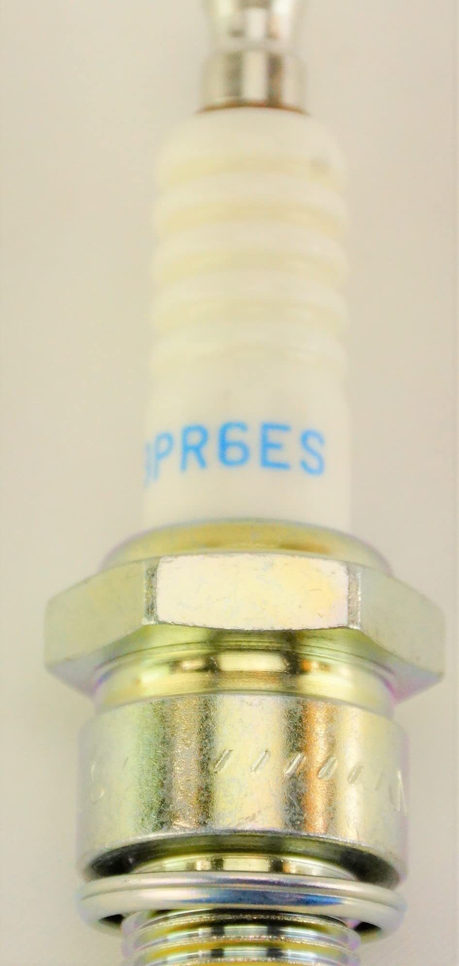 NGK triple-gasket sealing detail demonstrating leak prevention and reliability