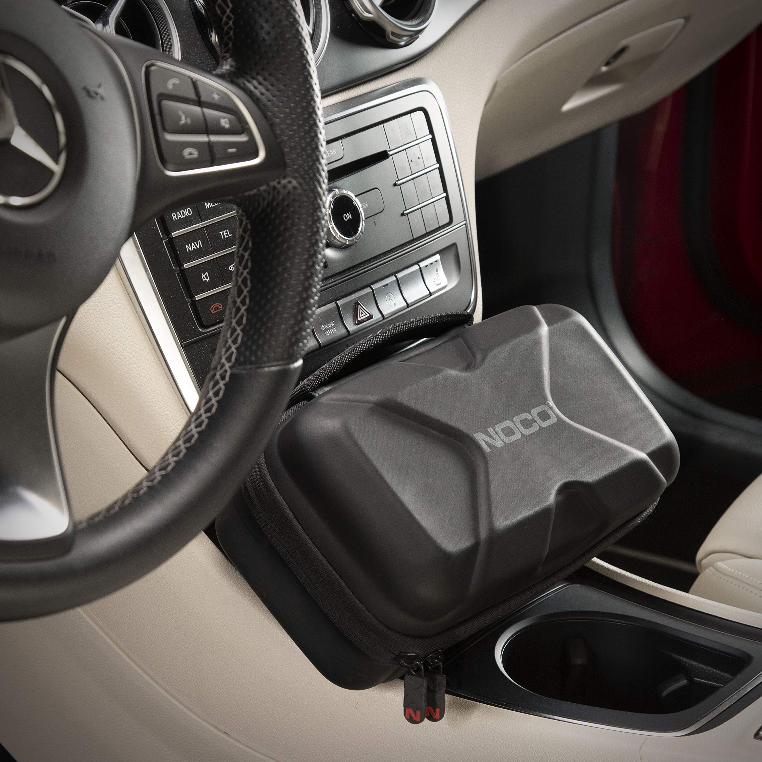 NOCO Boost XL case beside a car during roadside use offering quick access