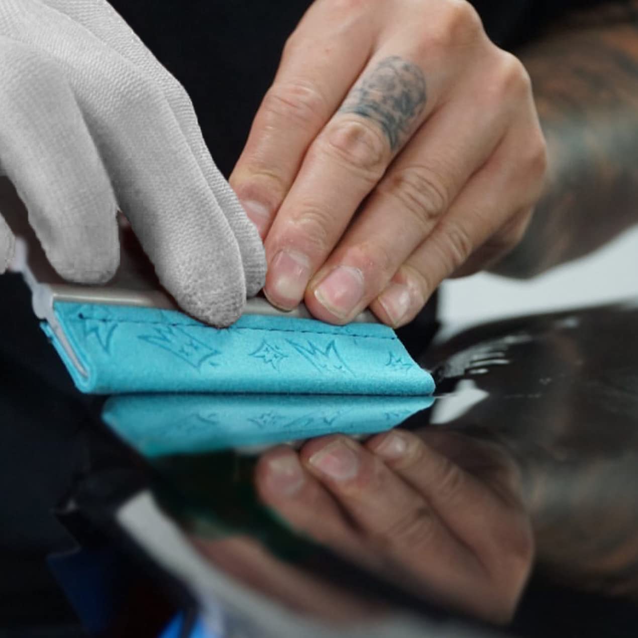 Off-Wrap squeegee next to hand to show size and ergonomic grip benefit