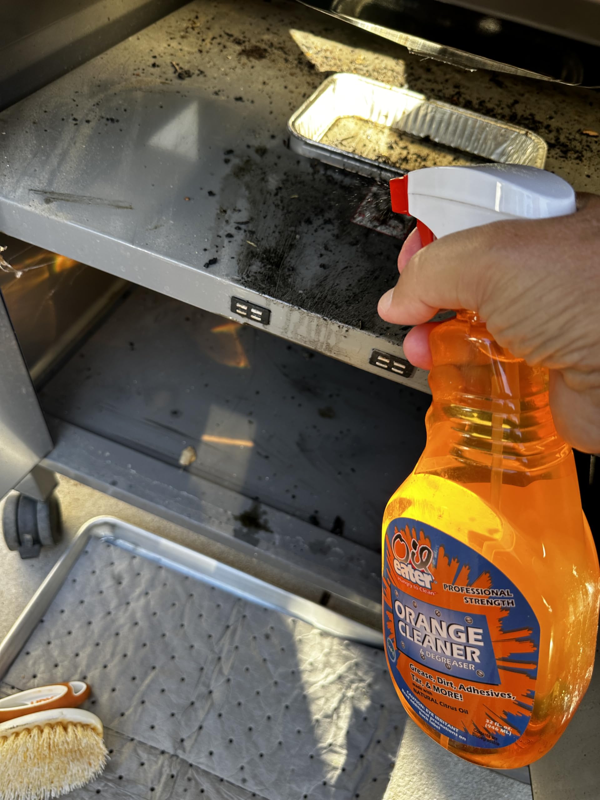 Oil Eater bottle held in hand for scale showing 32 oz size and convenience