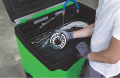 Pouring Oil Eater into parts washer to refill reservoir and save time