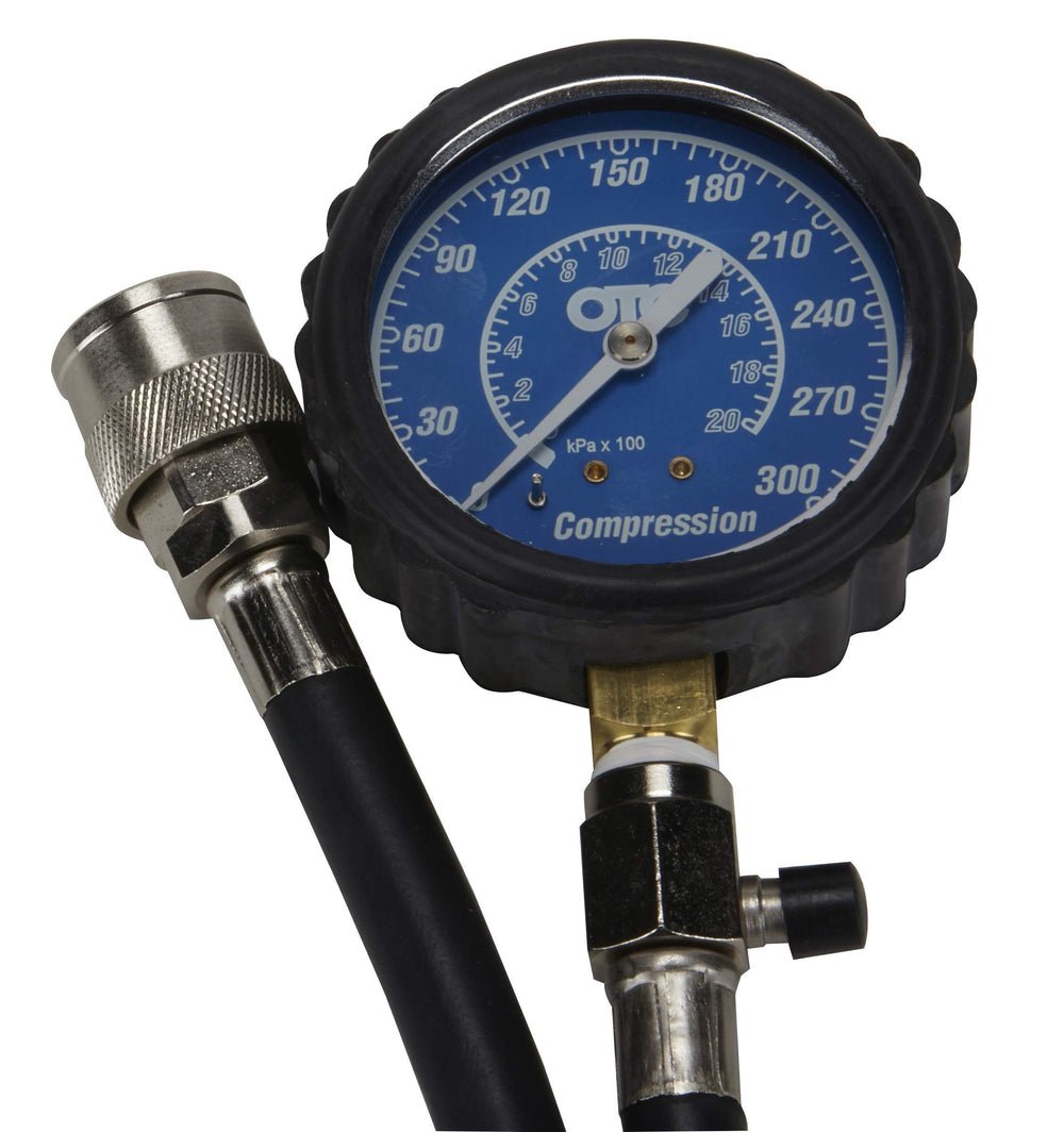OTC 5605 flex hose installed in an engine bay demonstrating long reach for tight spaces