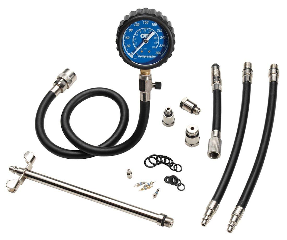 OTC 5605 gauge close-up showing dual-scale readout and protective boot for clear readings