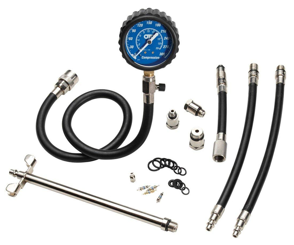 OTC 5605 gauge close-up showing dual-scale readout and protective boot for clear readings