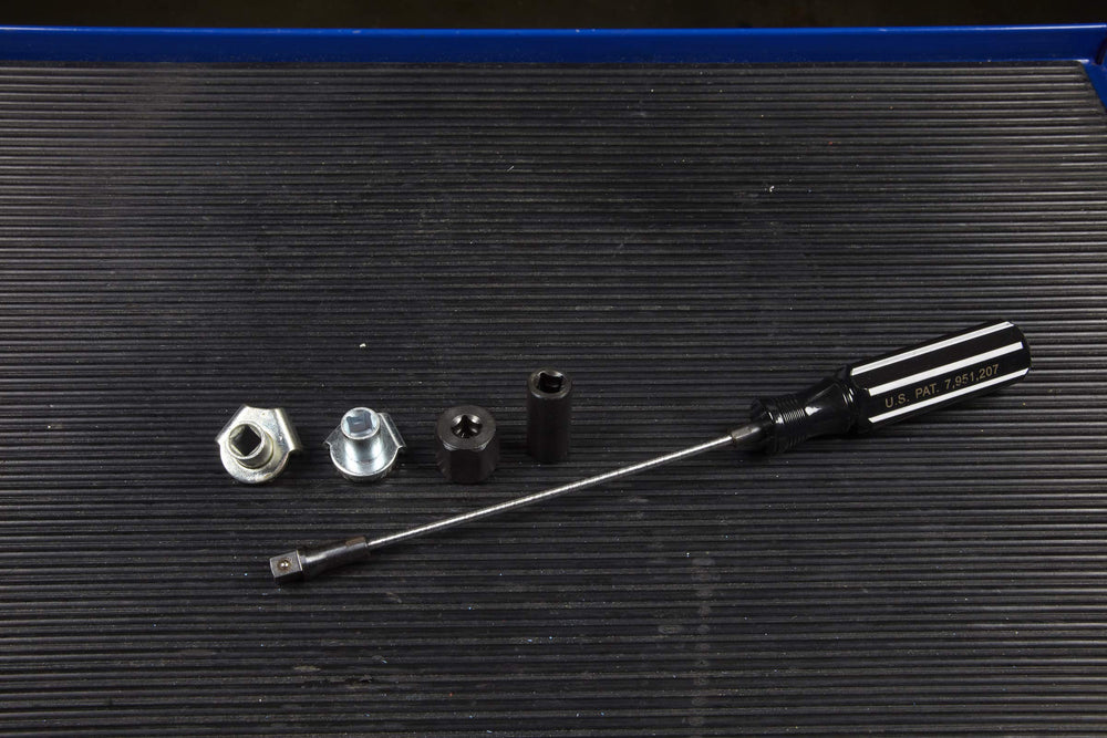 OTC 5961 beside a wrench showing compact scale and workshop convenience