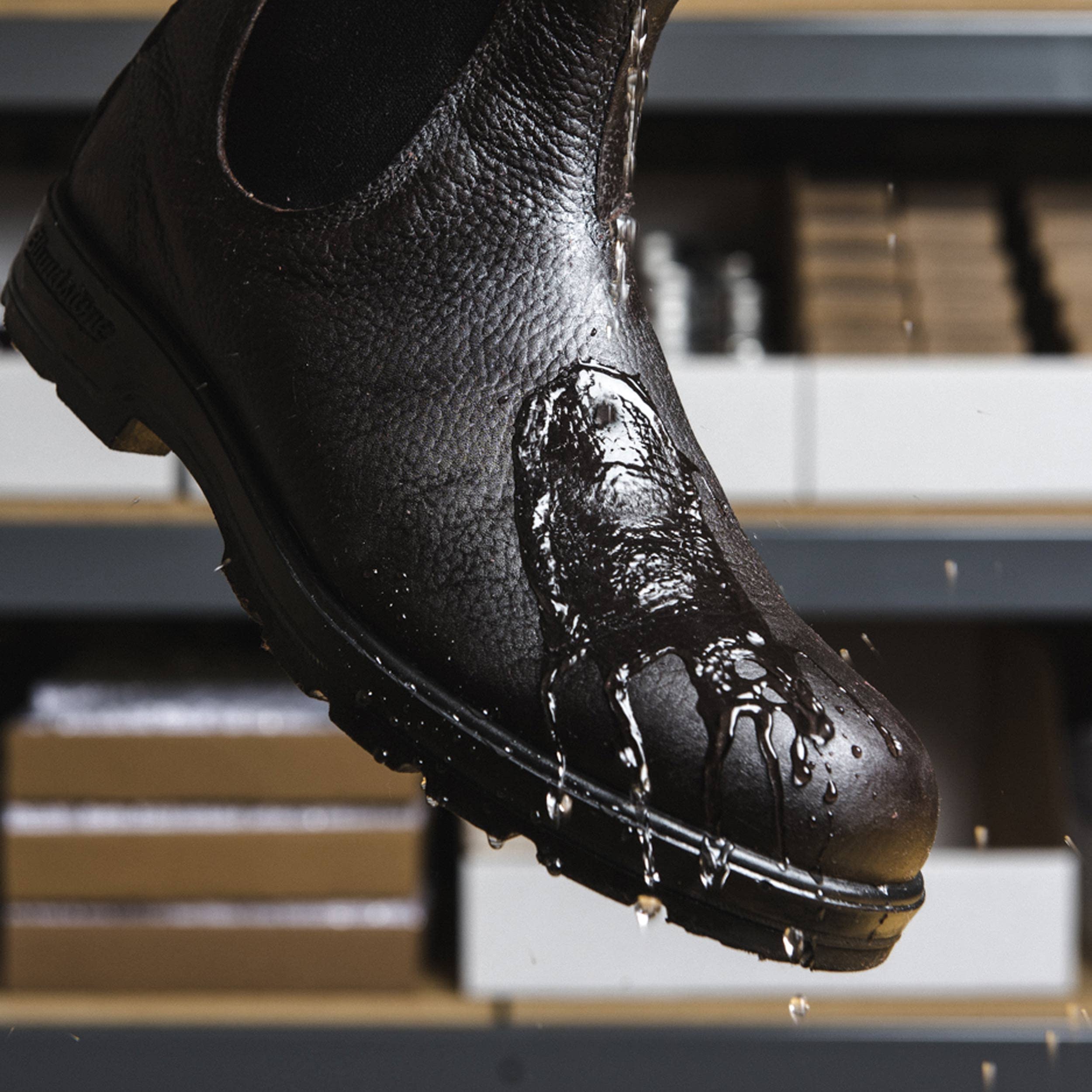 Otter Wax used on outdoor boots in wet grass for enhanced water resistance benefit