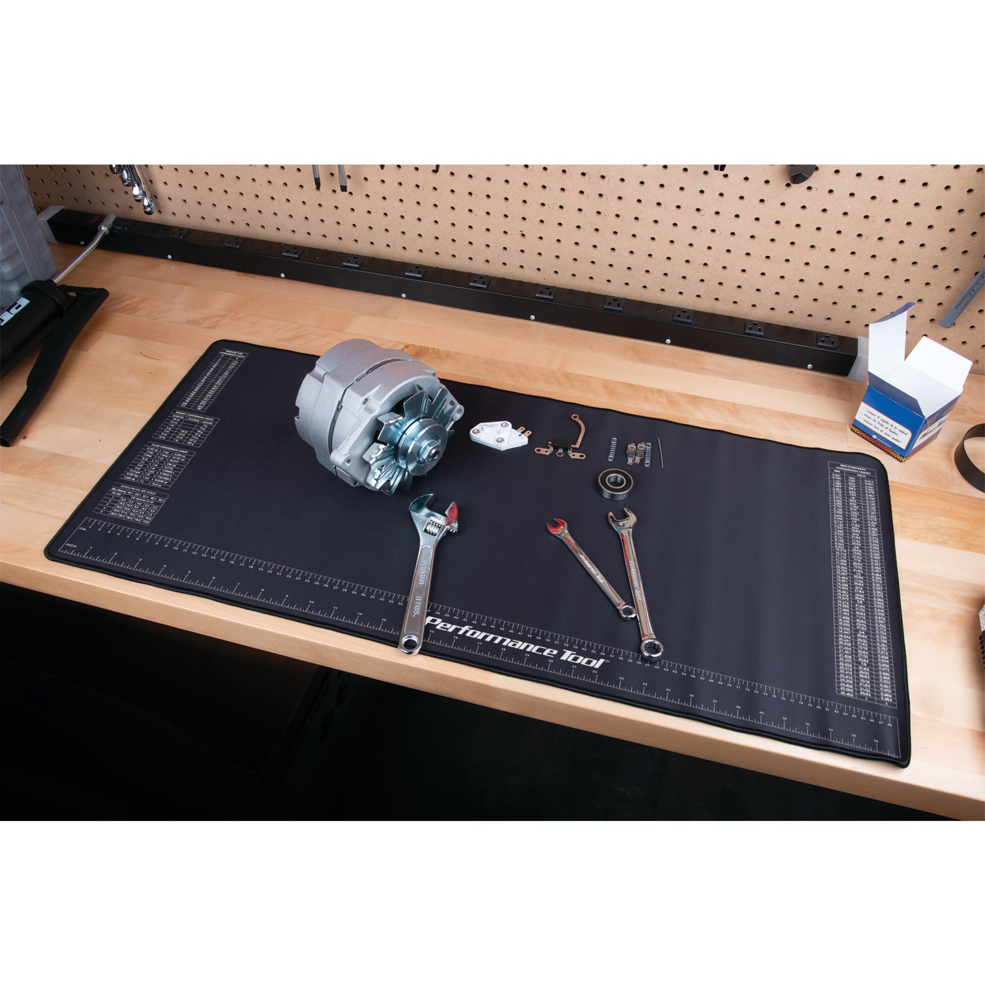 Performance Tool mat in use on garage bench, keeps workspace clean and safe